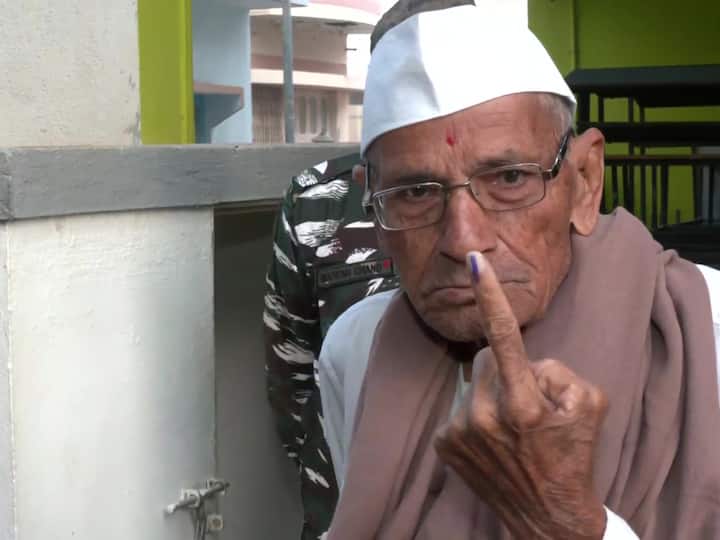 An elderly man shows his finger marked with indelible ink in Morbi during the first phase of the Gujarat assembly elections on Thursday. (Source: ANI)