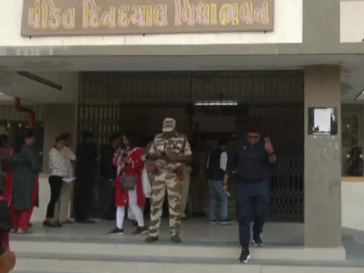 Voter walks out of VM Mehta College in Jamnagar after he casts his vote in the first phase Gujarat assembly elections on Thursday. (Source: ANI)
