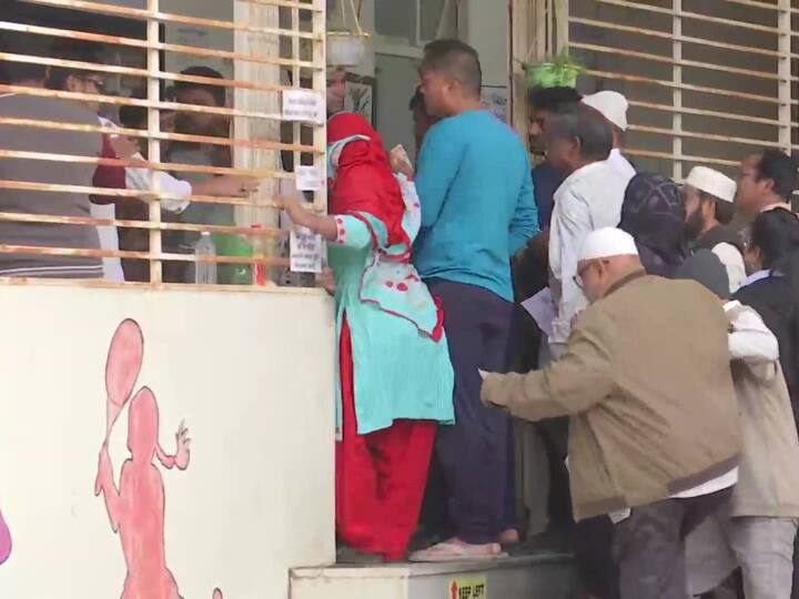 Voters queue up outside Piraman School in Ankleshwar, Bharuch for the first phase of the Gujarat assembly elections. (Source: ANI)
