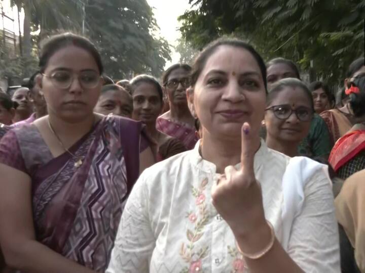 Woman voter shows her finger marked with ink after voting in Surat in the first phase of the Gujarat assembly elections on Thursday. (Source: ANI)
