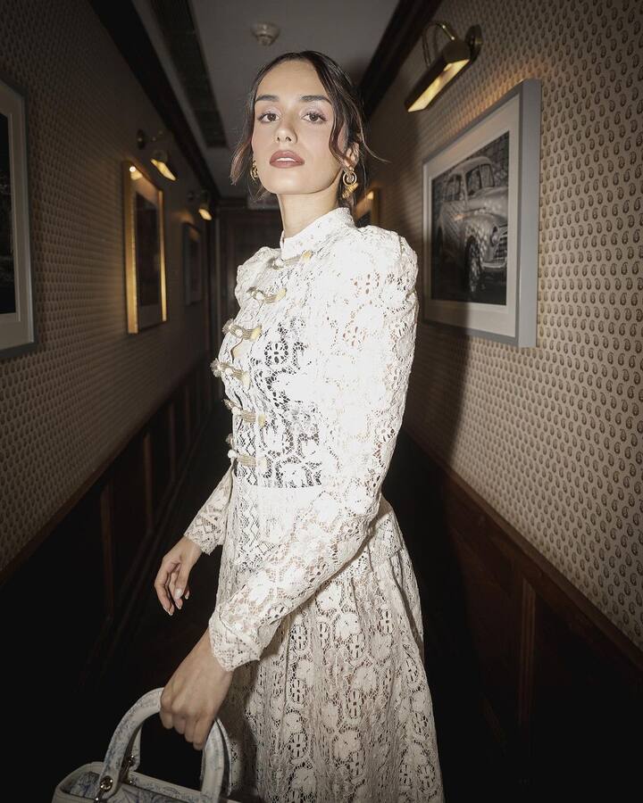 Dressed in a white mesh net dress, Manushi Chhillar exuded an air of refined sophistication. She also carried a Dior handbag that complemented her look.
