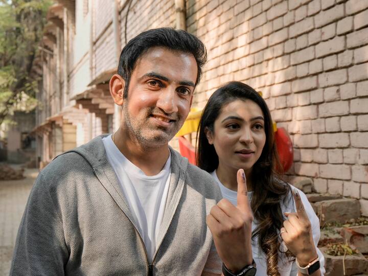 BJP MP Gautam Gambhir and his wife Natasha Jain show their fingers marked with indelible ink after casting their votes. Earlier, till 10:30 am around 9 per cent of voters' turnout was recorded in civic body polls. (Source: PTI)
