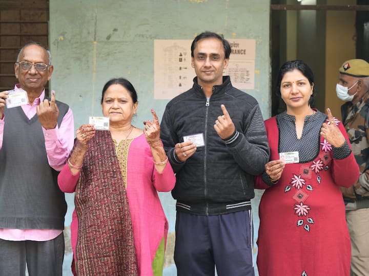 Voters show their fingers marked with indelible ink after casting their votes for the Municipal Corporation of Delhi (MCD) elections, at a polling station in Krishna Nagar area, in East Delhi on Sunday. (Source: PTI)