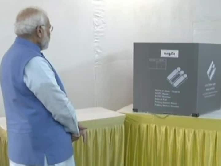 At the polling booth, PM Modi stood in the queue waiting for his turn to vote. (Image Source: ANI)