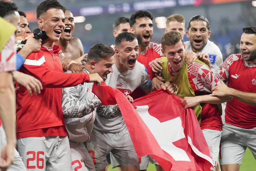 Players of Switzerland celebrate advancing into the round of 16 after the Group G match against Serbia at the 2022 FIFA World Cup at Stadium 974 in Doha, Qatar, Dec. 2, 2022.