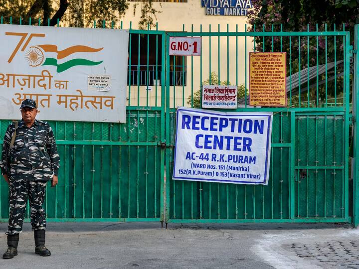A security personnel stands guard outside a strong room where EVMs are kept ahead of the counting of votes for the Municipal Corporation of Delhi (MCD) election. Twenty companies of paramilitary personnel and over 10,000 officers of Delhi Police have been deployed at the 42 centres ahead of results. (Source: PTI)