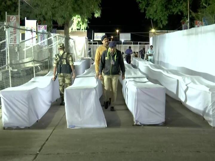 Police officials guard electoral machines covered in white cloth, before the counting of the Assembly election votes set to begin at 8 am in Ahmedabad. (Source: ANI)