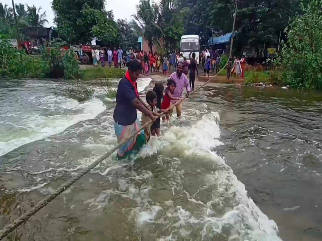 Due to the sinking of the footbridge the villagers are carrying their crops and transport is cut off in 10 villages TNN செய்யாறில் நீரில் மூழ்கிய தரைப்பாலம்.. கயிறு மூலம் கரையை கடக்கும் மக்கள்..!