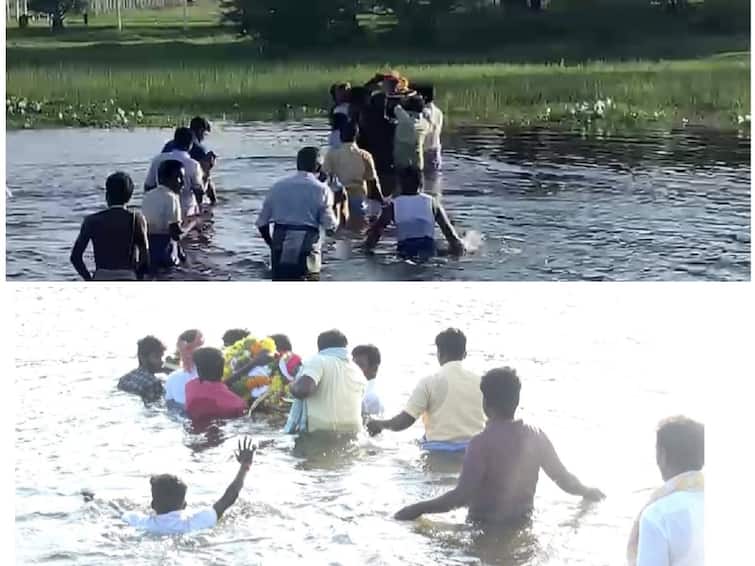 Villagers wade dangerously through neck-deep water to bury the dead TNN இறந்தவர் உடலை அடக்கம் செய்வதற்கு கழுத்தளவு நீரில் ஆபத்தான முறையில் பயணம் செய்யும் ஊர்மக்கள்