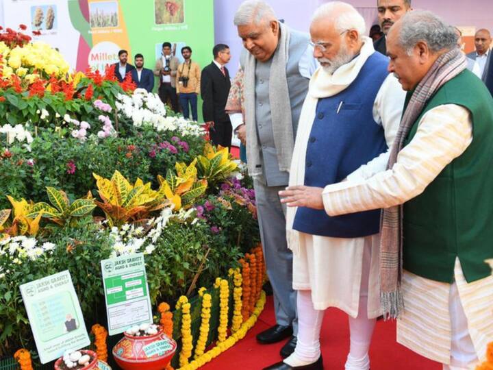 PM Modi and Vice-President Jagdeep Dhankhar check out an exhibition on Parliament premises along with Union Agriculture Minister Narendra Tomar. (Source: Twitter/@narendramodi)