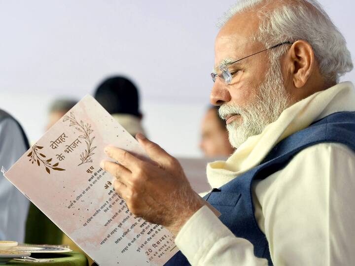 PM Modi takes a look at the menu before the special lunch. He enjoyed the lunch and tweeted about it, 'Good to see participation from across the party lines', as almost all the MPs present came together for the lunch. (Source: PTI)