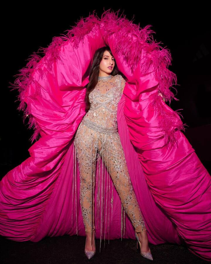 Her most recent looks at the 2022 FIFA World Cup Fan Fest in Qatar. Nora wore a pink and silver jumpsuit for the event.