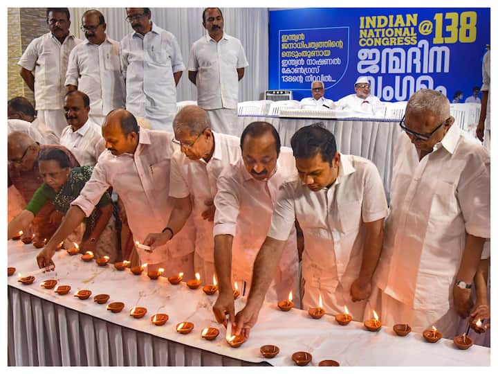 Congress leaders V.D. Satheesan, Hibi Eden and others light lamps during the party's 138th Foundation Day function, in Kochi. (Image: PTI)