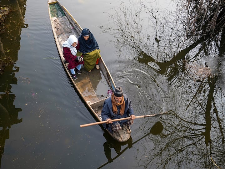 A boatman rows his boat in Dal Lake on a cold winter morning, in Srinagar. The city recorded minus 5.6 degree celsius temperature on Wednesday, the second lowest of the season, and the meteorological department has predicted moderate snowfall in the valley in the coming days. (PTI Photo/S. Irfan)