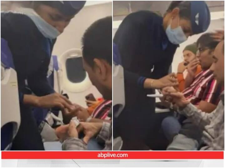 IndiGo air hostess providing mid-air medical assistance to a passenger Video: फ्लाइट में एयर होस्टेस ने यात्री के घाव पर लगाया बैंड-ऐड, सोशल मीडिया पर हो रही सराहना