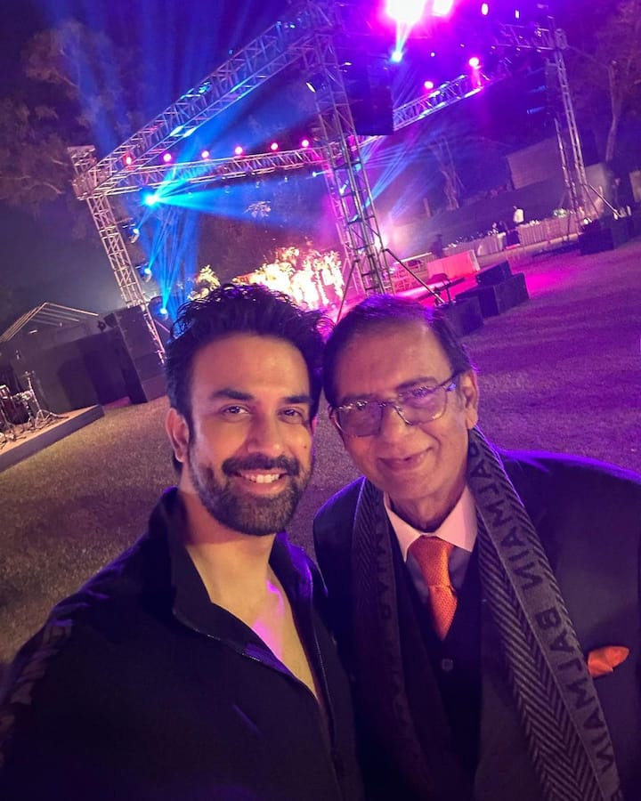 Rajeev posing with his father at the reception party.