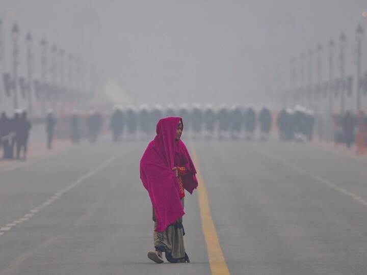 A woman wrapped in warm clothes walks on the Kartavya Path during a cold and foggy winter morning, in New Delhi, Friday, Jan. 6, 2023. (Source: PTI)