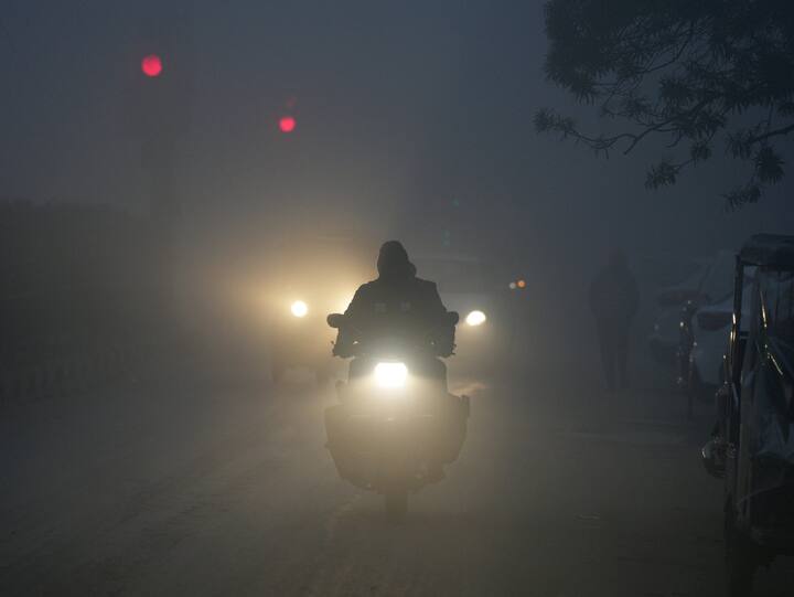 Vehicles ply on a road amid low visibility due to a thick layer of fog on a cold winter morning, in New Delhi. (Photo: PTI)