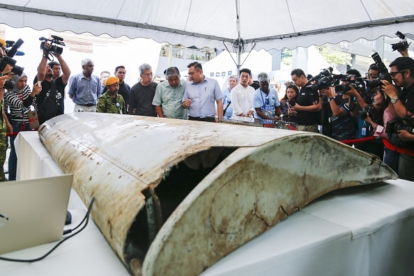 Malaysian Minister of Transport, Anthony Loke (C) looks at the Wing flap found on Pemba Island, Tanzania which has been identified a missing part of Malaysia Airlines Flight MH370 through unique part numbers traced to 9M-MRO during a commemoration event to mark the 5th anniversary of the missing Malaysia Airlines MH370 flight in Kuala Lumpur, Malaysia on March 03, 2019. (GettyImages)