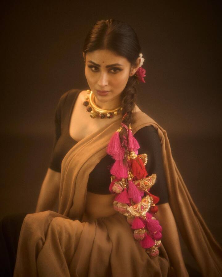 साडीच्या लूकमध्ये मौनीने केसांची लांब वेणी बनवली आहे. ज्यामध्ये त्याने फुलांचा गजरा देखील लावला आहे.