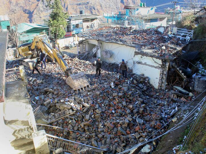 Workers demolish the PWD guest-house building in the land subsidence affected area in Joshimath. (Source: PTI)