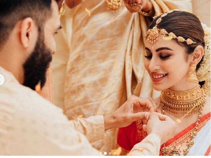 Mouni Roy: In a white silk Kasavu saree designed by Anuradha Khurana, Bengali girl Mouni Roy made for a stunning South Indian bride, paying homage to Suraj Nambiar's Malayali roots. The saree's regal appeal was enhanced by jacquard and brocade gold zari work with a bright red border. (Image Source: Instagram)