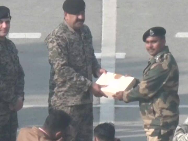 Personnel from both BSF and Pakistan Rangers at the Attari-Wagah exchange sweets. (Source: ANI)