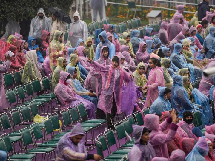People wearing raincoats sit to watch the Beating Retreat ceremony, at Vijay Chowk in New Delhi. (Image Source: PTI)