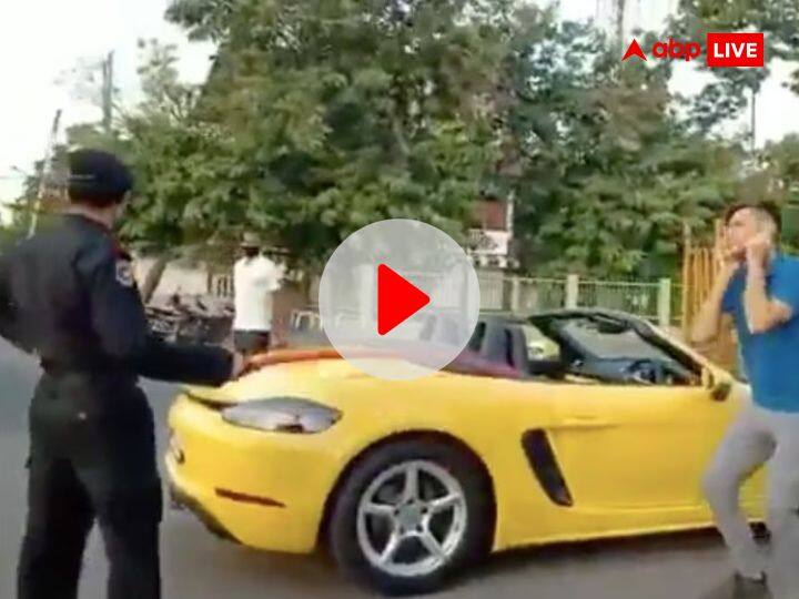 Watch Indore man riding Porsche car in covid 19 lockdown police stop him for sit-ups video viral Watch: इंदौर की सड़कों पर एक शख्स को पोर्शे कार चलाना पड़ा महंगा, पुलिस ने लगवाई उठक-बैठक, वीडियो वायरल