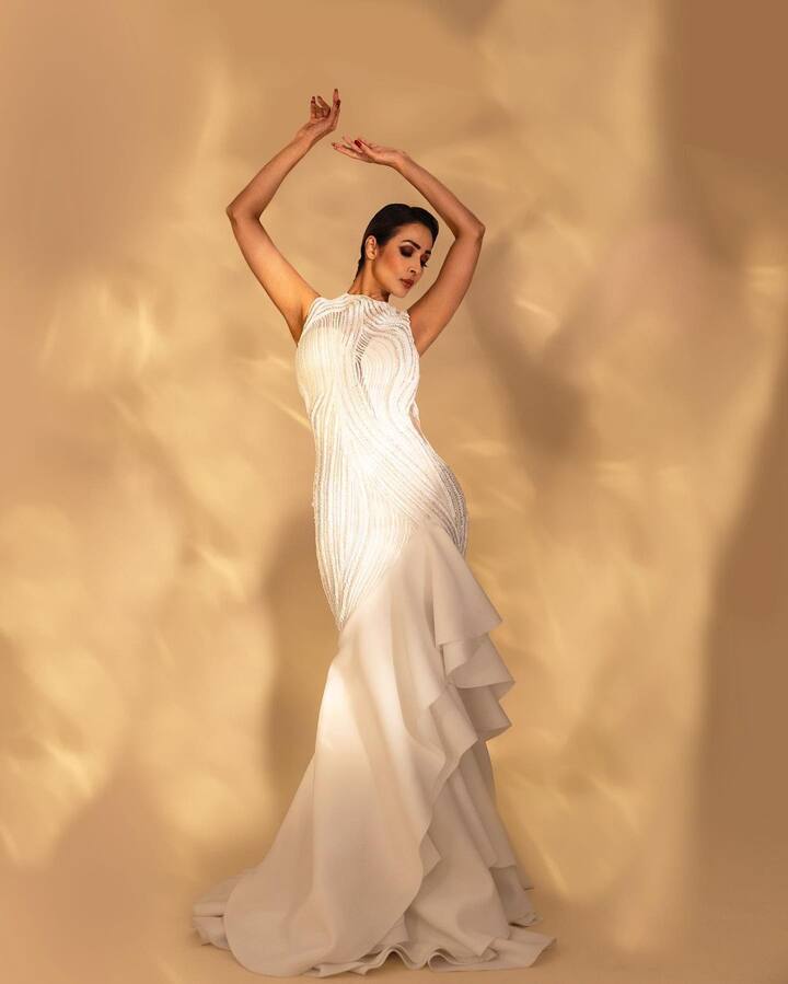 Malaika Arora looks stunning in this white gown with ruffled borders designed by Gaurav Gupta. (Image Source: Instagram)
