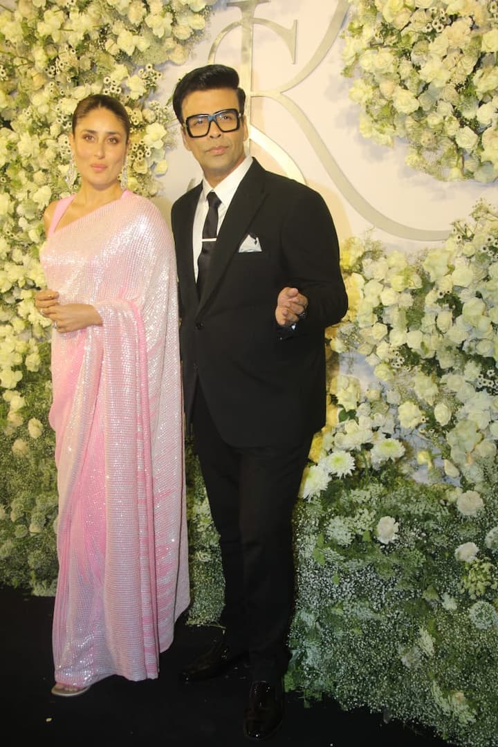 Kareena Kapoor Khan stunned in a baby pink shimmery saree that she paired with chandelier earrings. The actress struck a pose with filmmaker Karan Johar who was seen giving his blingy look a miss for the first time as he arrived in a classic black pantsuit look paired with a white shirt and black tie.