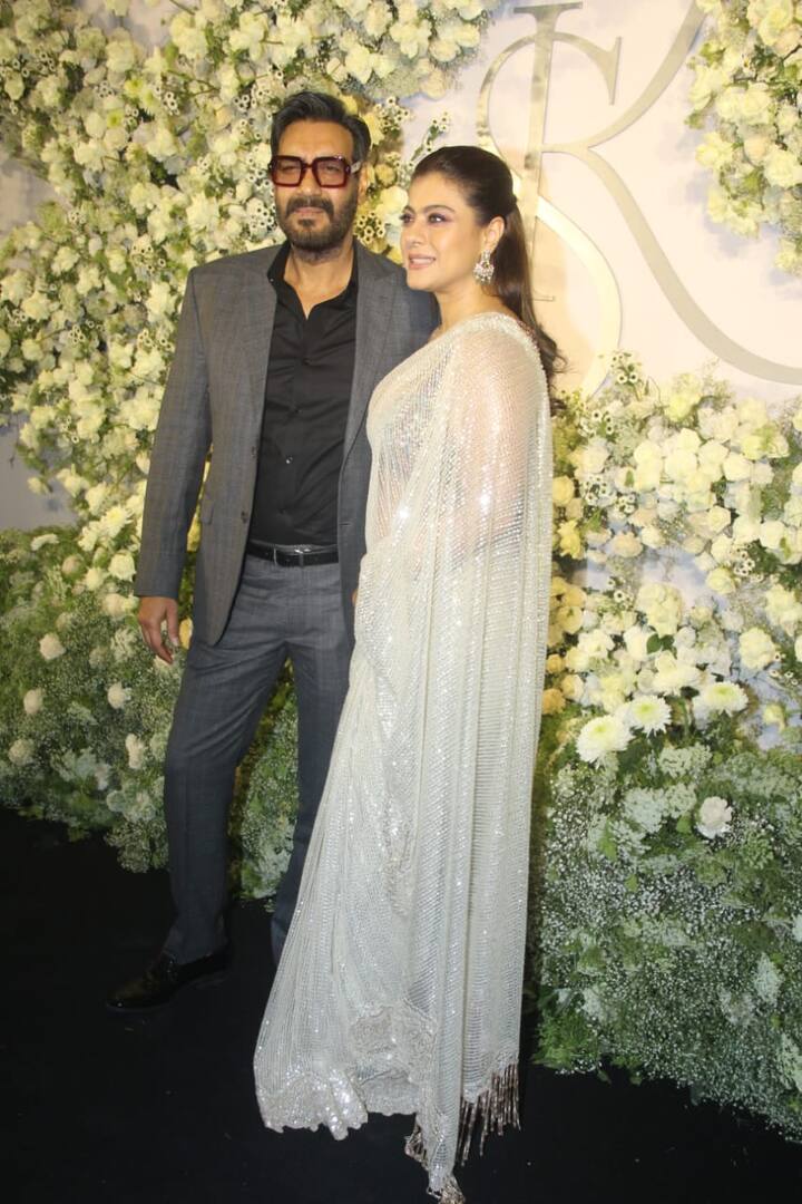 Power-couple Ajay Devgn and Kajol well-complemented each other in their black and white outfits. While Ajay opted for a grey pantsuit paired with a black shirt, Kajol looked mesmerising in a shimmery white saree. Her sleek hairstyle and statement earrings made her look eye-catching.