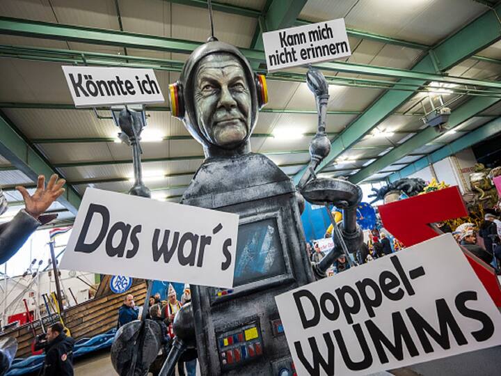 Olaf Scholz, the German chancellor, is shown on a float with the words 
