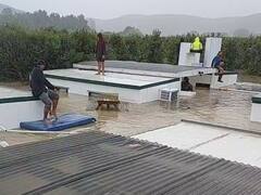 WATCH: Workers Use Refrigerators, Mattresses To Navigate Through Flooding In New Zealand