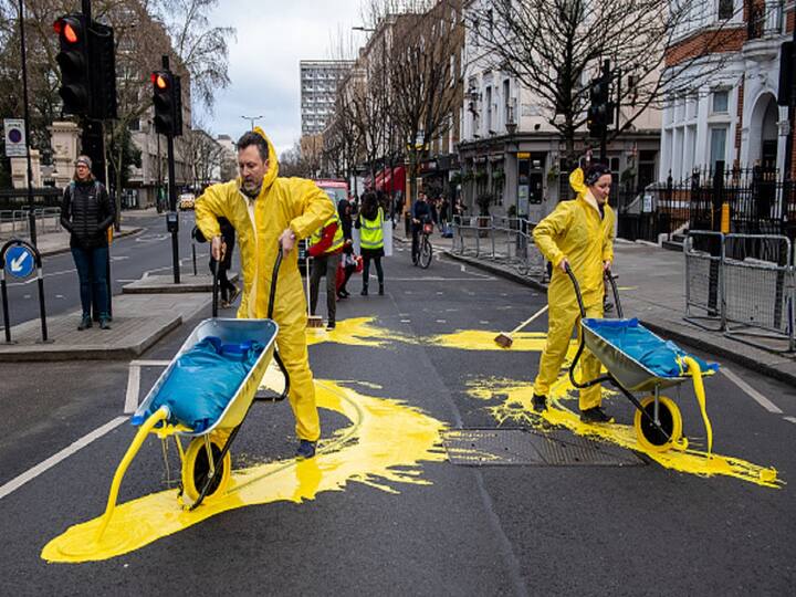 The Metropolitan Police of London said that three men and one woman had been taken into custody on suspicion of criminal damage and blocking the highway.