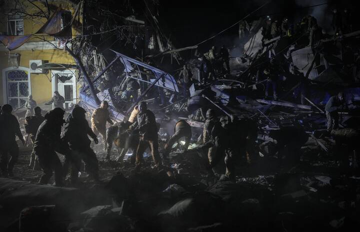 Ukrainian military soldiers, rescuers and local residents clean up rubble during a search and rescue operation in Kramatorsk, Ukraine after Russian forces are believed to have hit the building with an Iskander missile. On February 20, US President Joe Biden visited Kyiv ahead of the Russia-Ukraine conflict anniversary. Biden announced an aid package for Ukraine worth $500 million. (Image Credit: Getty Images)