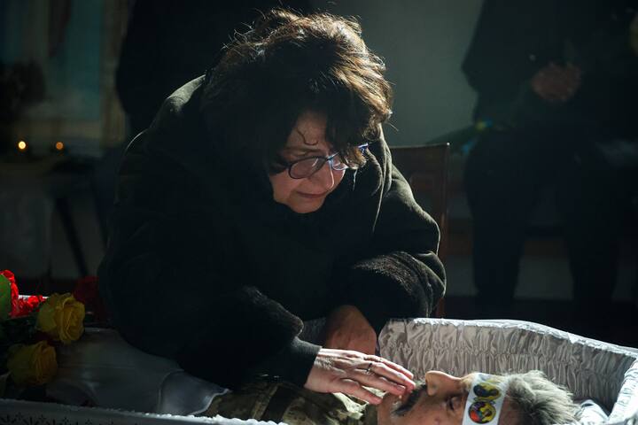 A woman mourns by the body of an activist during a funeral ceremony at a Church in Kharkiv, northeastern Ukraine. The casualties have only increased in the war. On January 14, a Russian missile hit an apartment building in the city of Dnipro killing 45. (Image Credit: Getty Images)