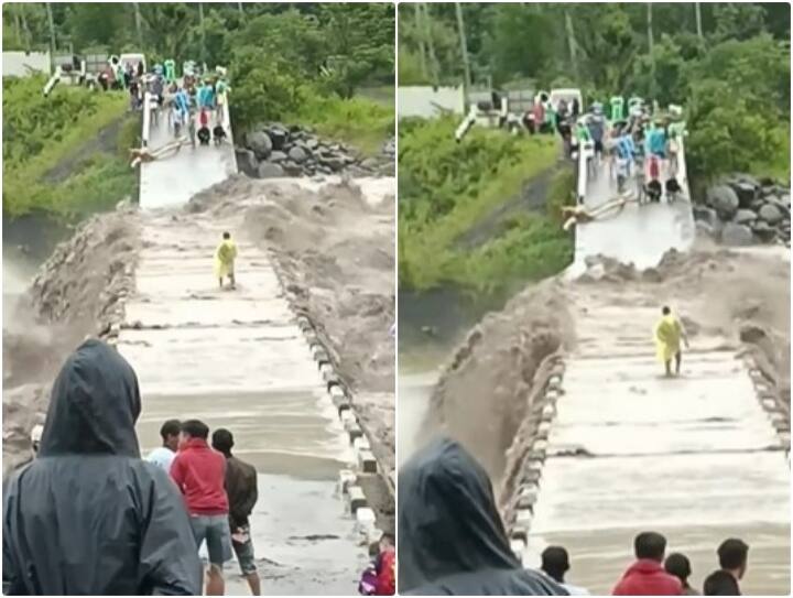 Viral Video Man trying to cross bridge over swollen river Video: पुल पर उफान मार रही नदी को पार करने की कोशिश कर रहा शख्स... आपने देखा ये वीडियो?