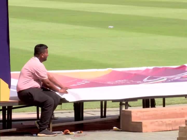 A man fixes a flex board to be displayed at the Narendra Modi Stadium. On Thursday morning, both prime ministers will arrive at the stadium in Ahmedabad to watch the first-day play of the fourth Test between Australia and India. They will leave after watching the match for a few hours. (Source: ANI)