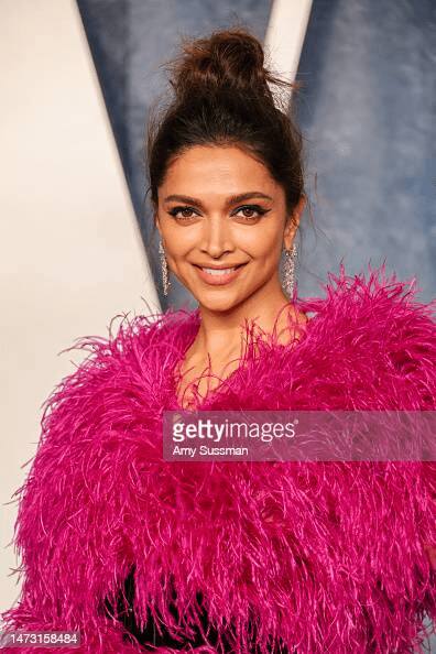 Deepika made a messy knot with her silky hair by pulling it back.