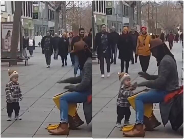 Kid is seen dancing to the beats of a street artist Video: स्ट्रीट म्यूजिशियन की धुन पर छोटे बच्चे की हरकतों ने जीता दिल, वीडियो हुआ वायरल