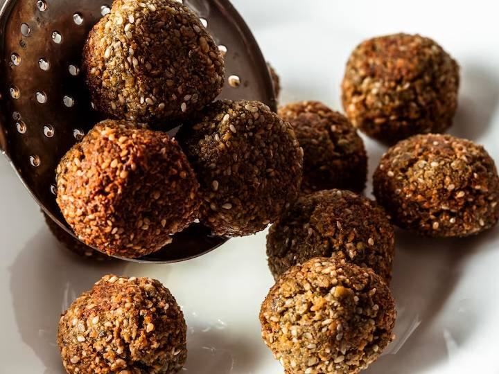 ओटमील बॉल एक स्वादिष्ट नो-बेक स्नैक/डेज़र्ट रेसिपी है. जिसे आप बहुत ही कम समय में बना सकते हैं. अगर आपके घर में बच्चे हैं, तो आपको यह आसान सी रेसिपी जरूर आजमाना चाहिए. यह हेल्दी और स्वादिष्ट ओटमील बॉल रेसिपी बच्चों को बहुत पसंद आएगी. इस बॉल को बनाने में हमने रिफाइंड चीनी की जगह शहद का इस्तेमाल किया है, जो इस स्नैक को हेल्दी बनाता है. बॉल्स को स्वादिष्ट और क्रंची बनाने के लिए हमने ढ़ेर सारे ड्राई फ्रूट्स जैसे बादाम, काजू, अखरोट का इस्तेमाल किया है. यह एक नो-बेक रेसिपी है और इसे कोई भी बना सकता है.