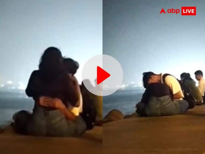 Mumbai couple kissing at Mumbai Marin drive video goes viral Video: समुद्र किनारे बैठे कपल पर चढ़ा रोमांस का रंग, मुंबई की मरीन ड्राइव पर किस करने का वीडियो वायरल