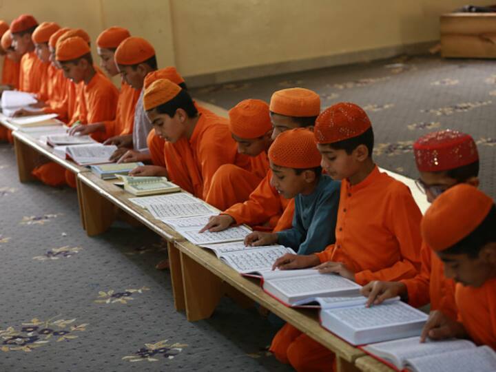 Students read the Holy Quran at Dars-e-Noor Madrasa (Islamic seminary) in the city of Lala Musa in Pakistan during the holy month of Ramadan. Muslims believe that the Quran was revealed to Prophet Muhammad in this holy month.