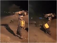 सैकड़ों लकड़बग्घों के बीच से पानी और लकड़ी लेकर गुजरी महिला, हिम्मत को सलाम कर रहे यूजर्स