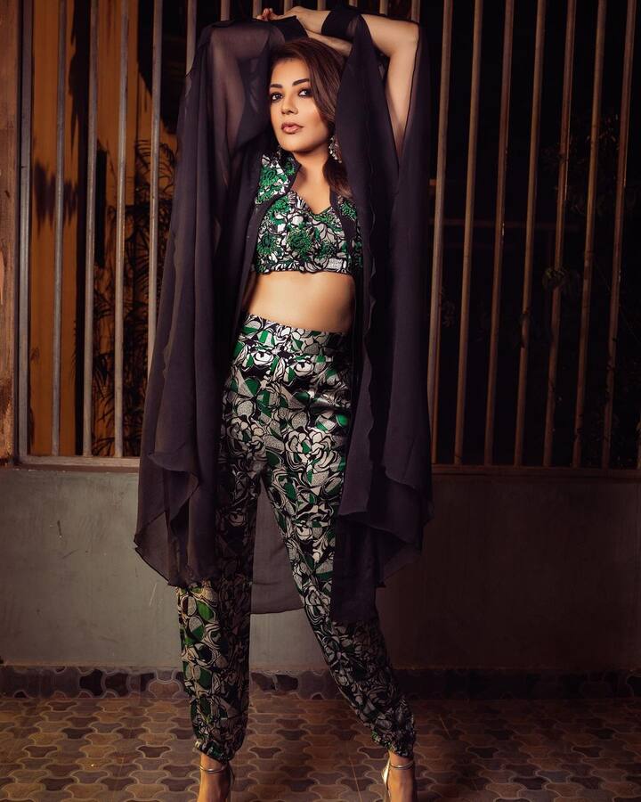 In her latest photoshoot, she posed in a green jumpsuit with quirky patterns all over it in black and white. (Image Source: Instagram/ Kajal Aggarwal)