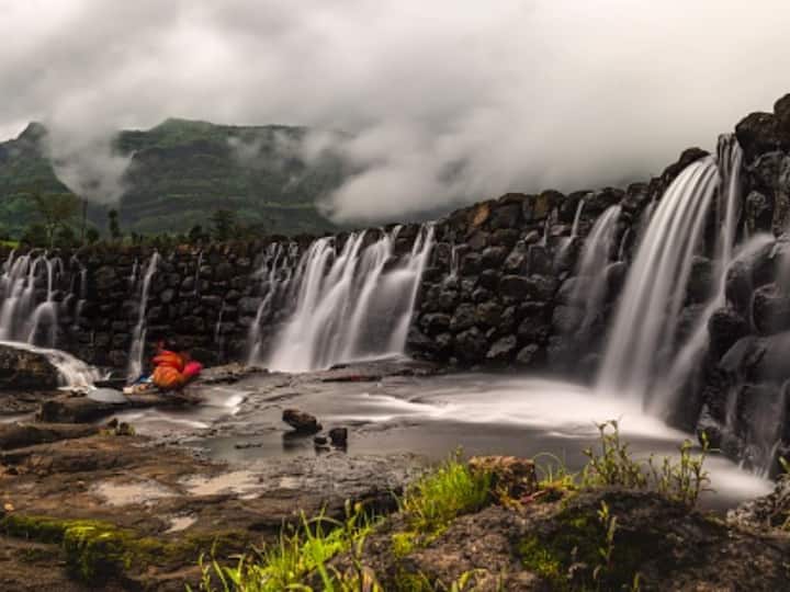 Bhandardara in Maharashtra: Bhandardara is a charming hill station near Mumbai, situated on the banks of the Pravara River and nestled in the Sahayadri mountain ranges, is ideal for a summer getaway for Indian families. The hill station, which is only 185 kilometres from Mumbai, allows you to experience a relaxing weekend away from the city. It's a great weekend destination because of the waterfalls, long walks through the lush green fields, and scenic vistas. (Image Source: Getty)