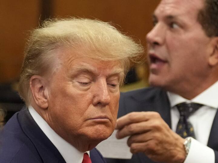 Former US president Donald Trump (L) appears in court at the Manhattan Criminal Court in New York on April 4, 2023. He arrived for a historic court appearance in New York on Tuesday, facing criminal charges that threaten to upend the 2024 White House race.