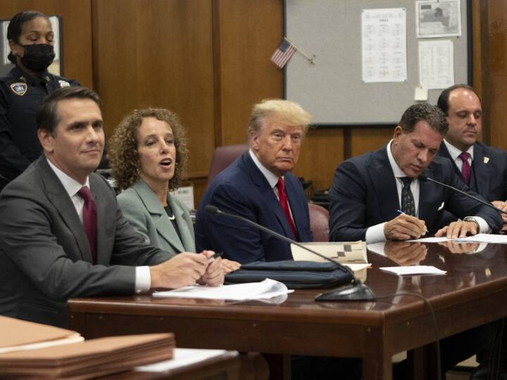 Former US president Donald Trump (C) appears in court at the Manhattan Criminal Court in New York on April 4, 2023. Trump was charged with 34 felony counts of falsifying business records stemming from three pre-election hush-money cases, prosecutors said.