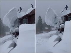 आरी से काटकर हटाई गई घर की छत से बर्फ की बड़ी-बड़ी स्लैब, ये सीन आपके कहीं नहीं मिलेगा